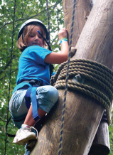 A camper tackles the rope course at Camp Wekandu. Activities are adapted to the campers’ ability levels.