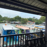 Small, colorful ferry boats docked at Pulau Ubin